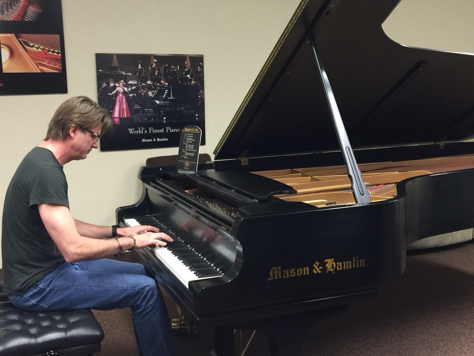 At the keys of a Mason & Hamlin grand in the factory showroom.