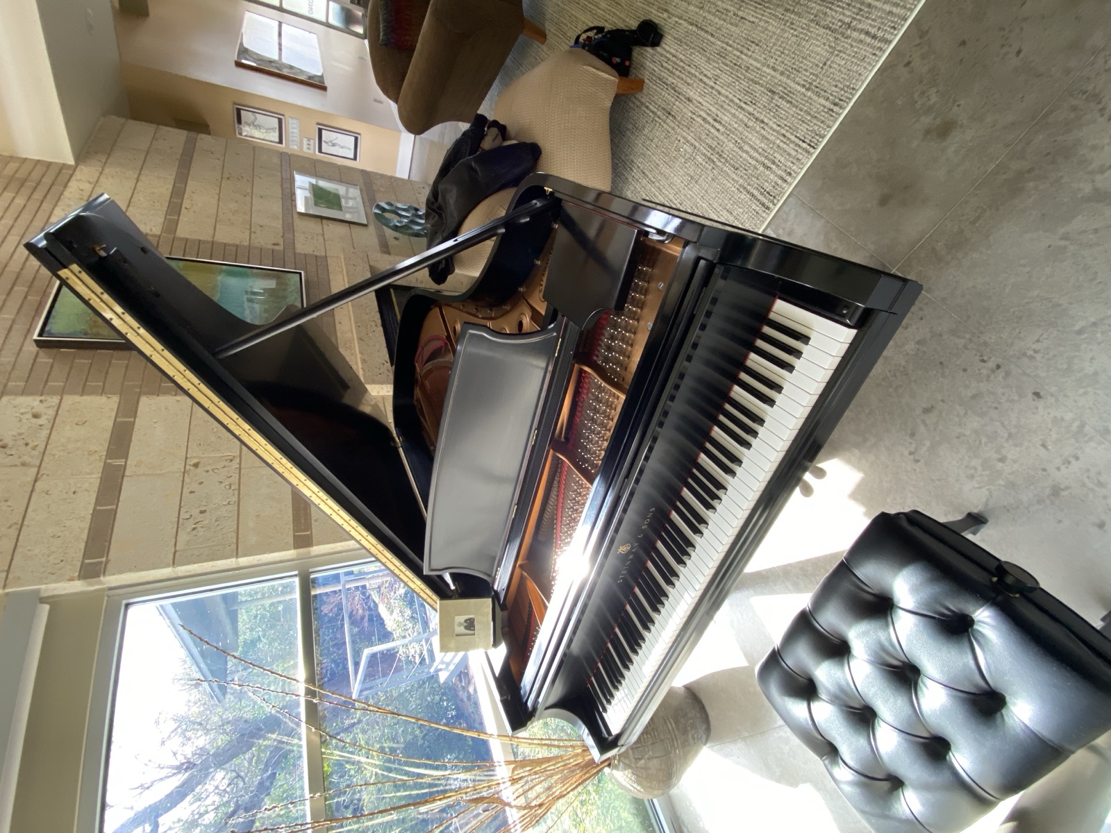 Black grand piano in a modern Dallas–Fort Worth home.